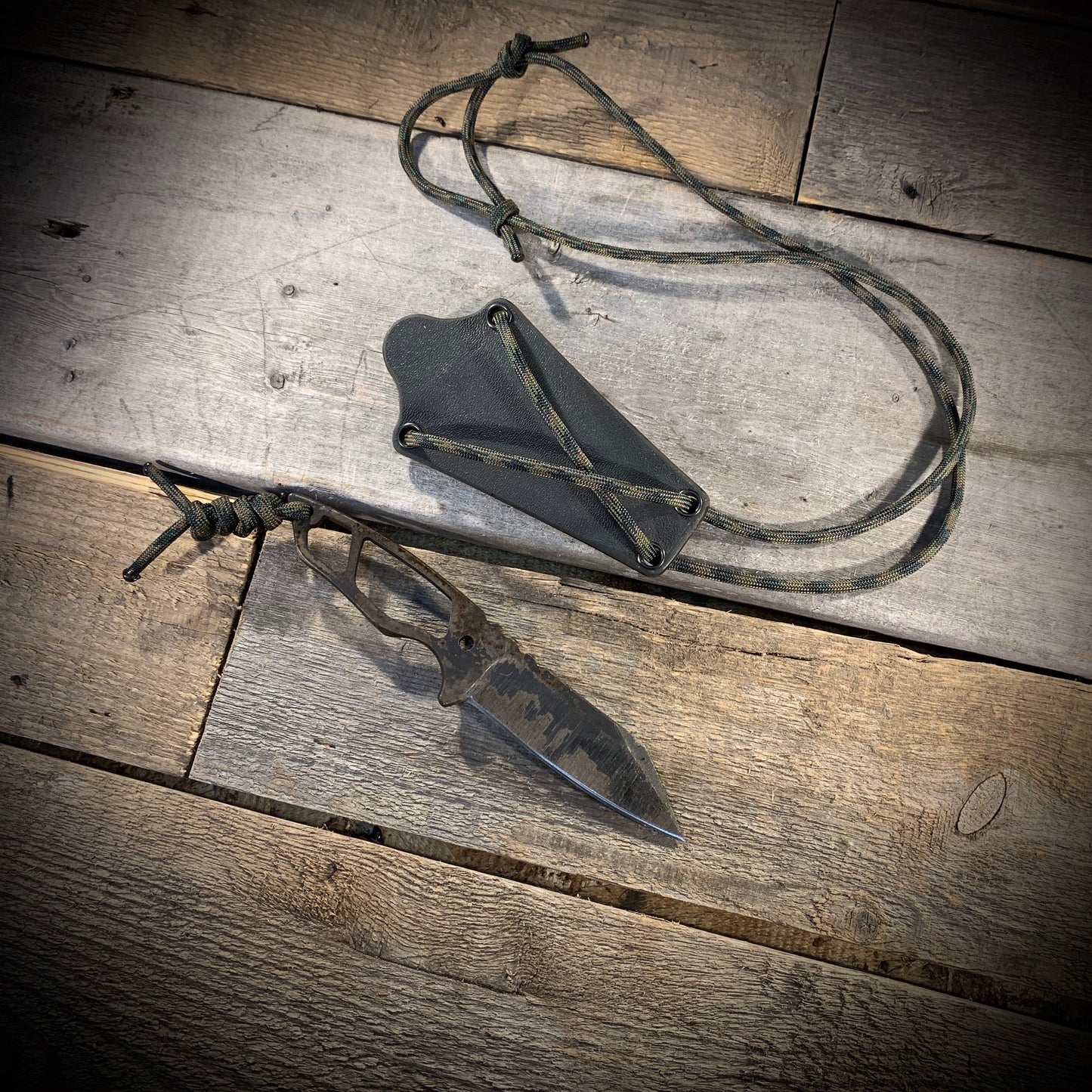 Hand Forged 1095 High Carbon Steel Neck Knife, perfect for Hiking and Bushcraft. Handmade by blacksmith Graeson Fehr In Winnipeg Manitoba Canada. Perfect for hiking, with durable black finish and paracord handle wrap.