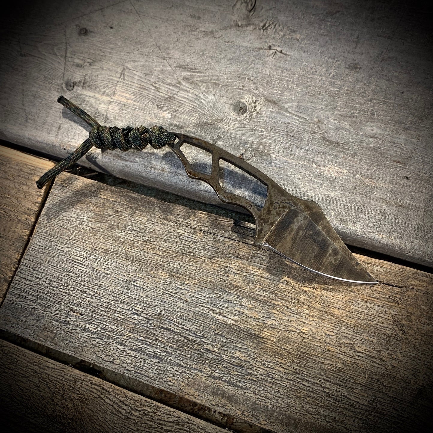 Hand Forged 1095 High Carbon Steel Neck Knife, perfect for Hiking and Bushcraft. Handmade by blacksmith Graeson Fehr In Winnipeg Manitoba Canada. Perfect for hiking, with durable black finish and paracord handle wrap.