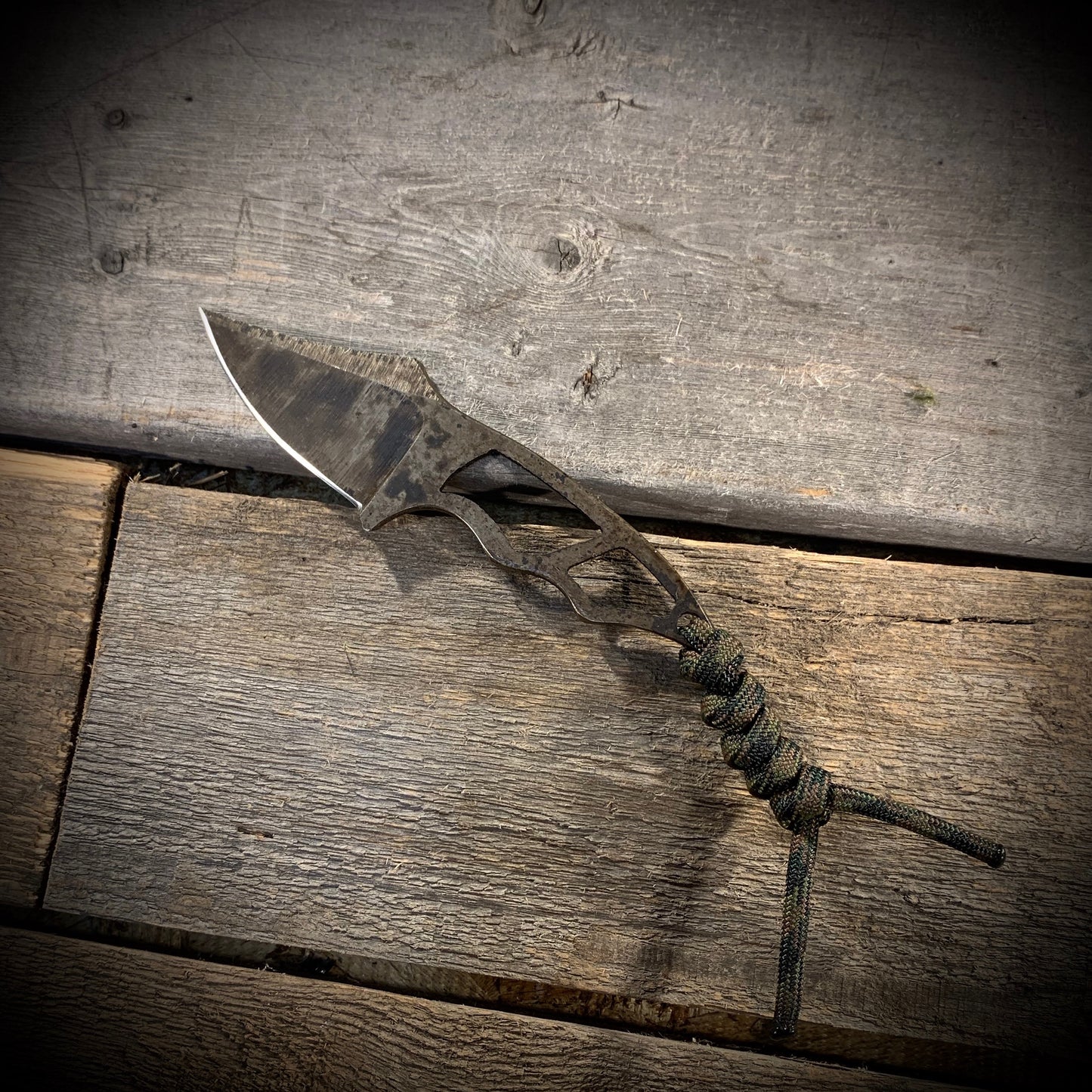 Hand Forged 1095 High Carbon Steel Neck Knife, perfect for Hiking and Bushcraft. Handmade by blacksmith Graeson Fehr In Winnipeg Manitoba Canada. Perfect for hiking, with durable black finish and paracord handle wrap.