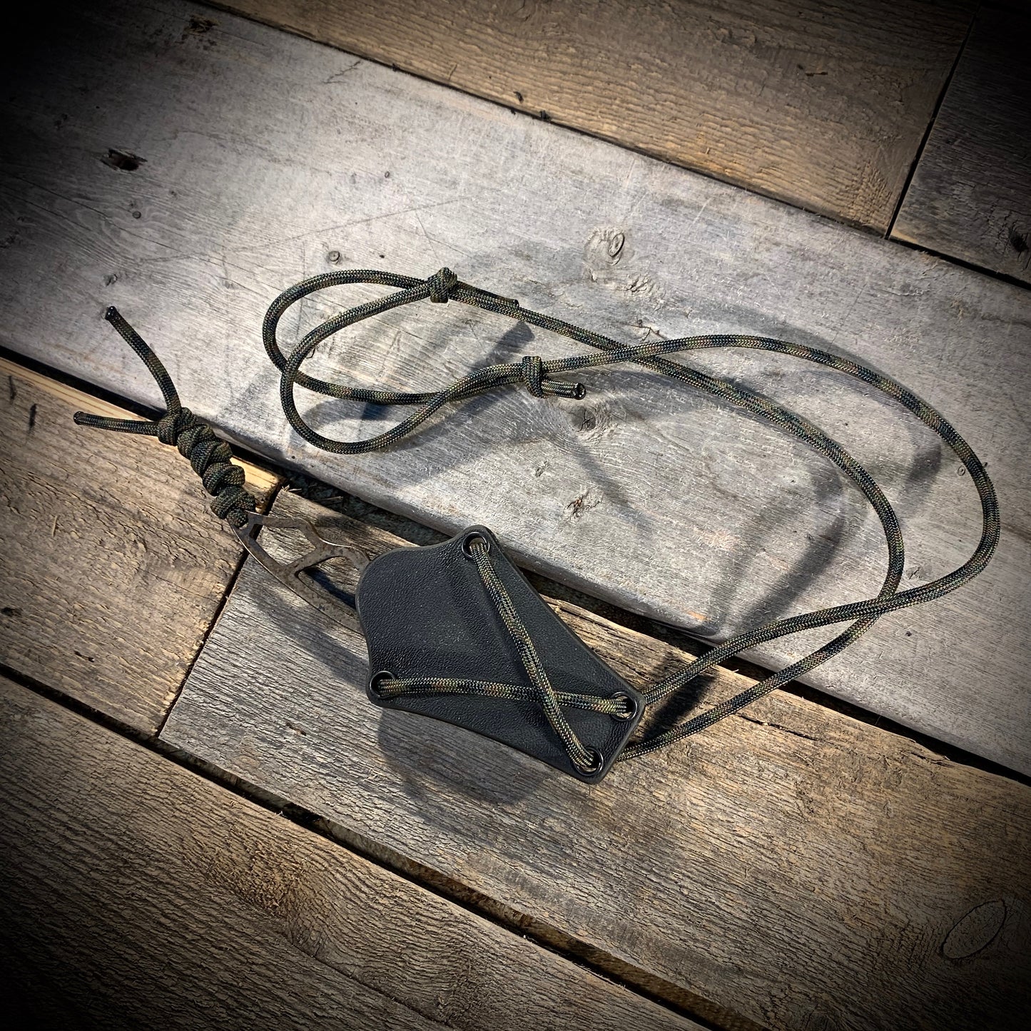 Hand Forged 1095 High Carbon Steel Neck Knife, perfect for Hiking and Bushcraft. Handmade by blacksmith Graeson Fehr In Winnipeg Manitoba Canada. Perfect for hiking, with durable black finish and paracord handle wrap.