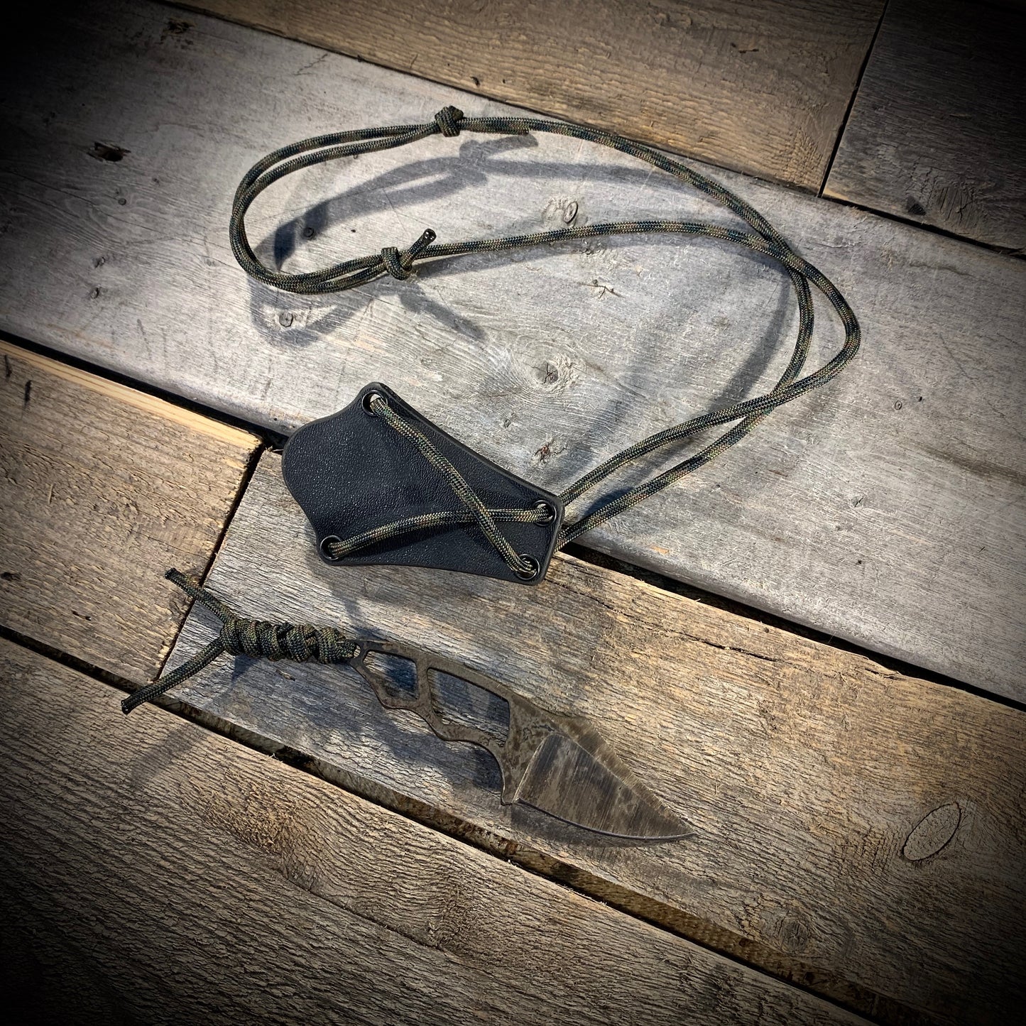 Hand Forged 1095 High Carbon Steel Neck Knife, perfect for Hiking and Bushcraft. Handmade by blacksmith Graeson Fehr In Winnipeg Manitoba Canada. Perfect for hiking, with durable black finish and paracord handle wrap.