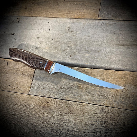 Hand Forged High Carbon Steel Filleting Knife. Designed for medium sized fish, with durable exotic wood handles. Handmade in Winnipeg Manitoba Canada