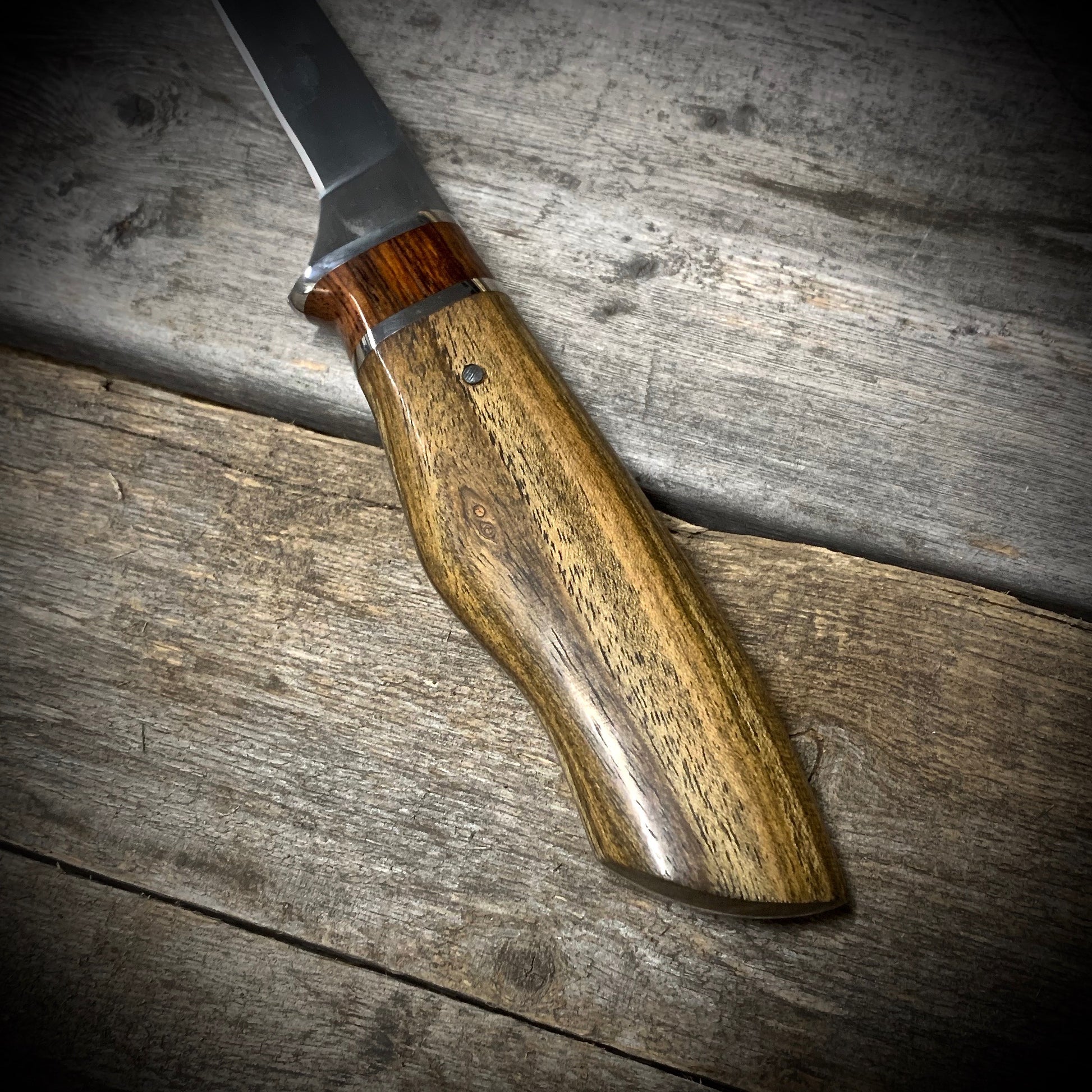 Hand Forged High Carbon Steel Filleting Knife. Designed for medium sized fish, with durable exotic wood handles. Handmade in Winnipeg Manitoba Canada