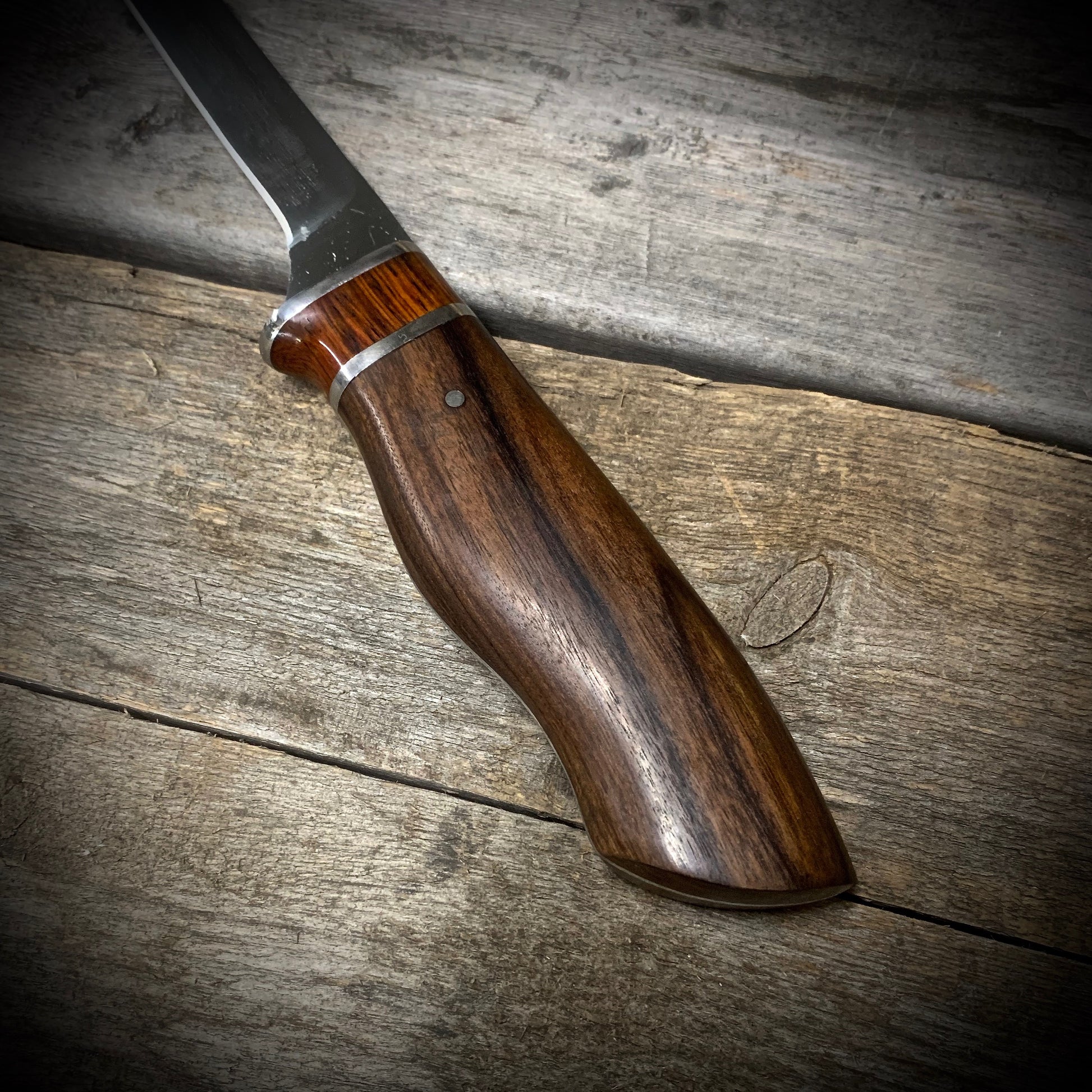 Hand Forged High Carbon Steel Filleting Knife. Designed for medium sized fish, with durable exotic wood handles. Handmade in Winnipeg Manitoba Canada